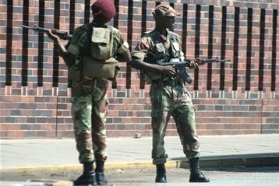 Armed military police officers stand guard near the entrance of Harare Central police station (file photo).