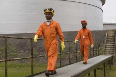 Workers at LNG storage tanks in Nigeria