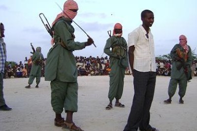 Members of the Islamist militia al Shabaab whip a suspected criminal.