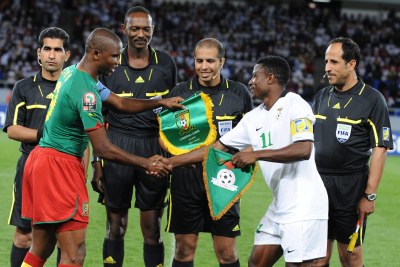 Samuel Eto'o of Cameroon and Chris Katongo of Zambia with Referee officals during the African Nations Cup match between Cameroon and Zambia from the Alto da Chela Stadium in Lubango on January 17, 2010 in Luanda, Angola.