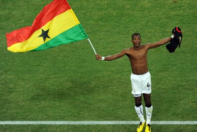 Ghanaian defender John Pantsil celebrates his team's progress to the second round of the World Cup, and Saturday's match against the United States.