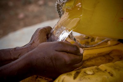 Fresh water being poured into a jerrycan.