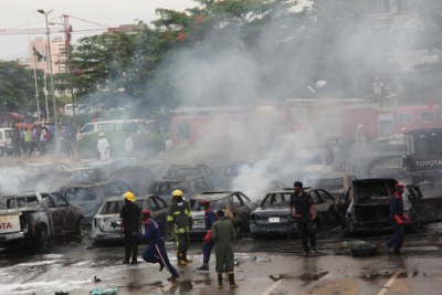 Fire fighters at the scene of the bomb blast at the Car Park, Police Force Headquarters, Abuja.16/06/2011