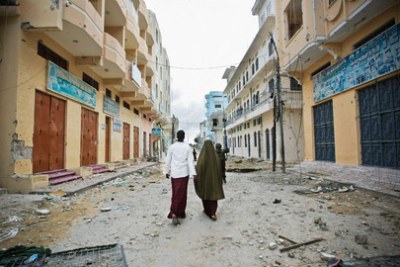 A man and woman walk through a deserted street in Mogadishu (file photo).