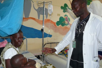 A doctor in Siaya, Kenya attends to a child with malaria (file photo)