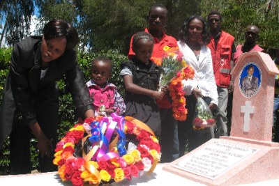 IN MEMORY: Samuel Wanjiru's widow Trizah Njeri and family laying wreaths at his grave.
