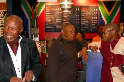 Alfred Kumalo, left, with musician Hugh Masekela, center, and journalist Joe Thloloe at the launch of the book 
