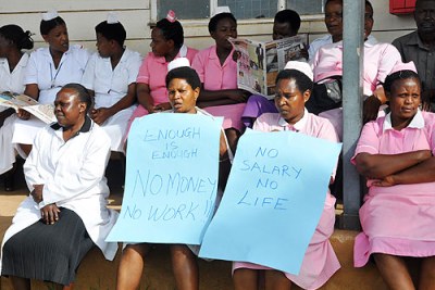 Medics holding placards at Mbarara Hospital.