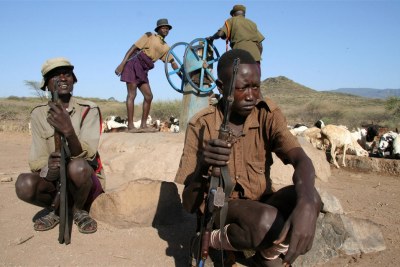 Turkana men armed with AK-47 rifles next to a water pump in north-western Kenya (file photo).