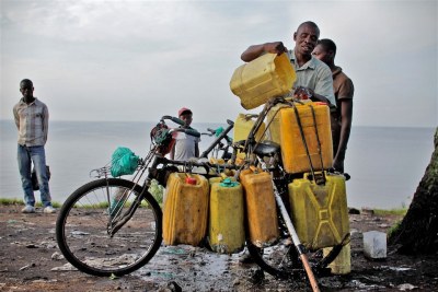 A man loads water collected from Lake Kivu onto his bicycle for sale in the city of Goma.