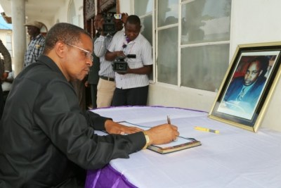 President Jakaya Kikwete signing a condolence book in honour of Constitution Review Commission member, Dr. Sengondo Mvungi.