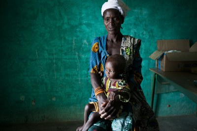 Awa waits with her son Modiba, two, to receive medication for severe malnutrition and malaria.