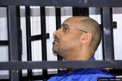 Saif al-Islam Gaddafi attends a hearing behind bars in a courtroom in Zintan on May 25, 2014.