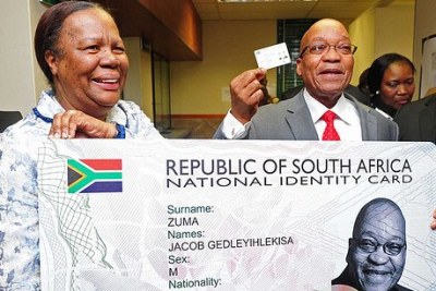 President Jacob Zuma receives his smart ID card from previous Minister of Home Affairs Naledi Pandor (file photo).