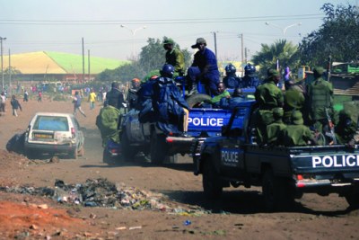 Riot police officers during a raid of Chibolya compound in Lusaka.