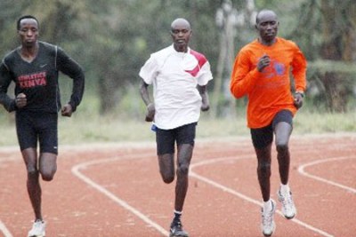 Paralympics team's Henry Kirwa (right) with Abraham Tarbei (centre) in action during a past training session.