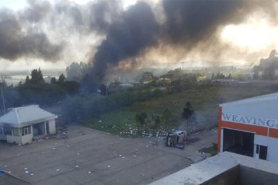 Factories and flower farms in Alem Gena town were torched during reported rioting in Ethiopia after more than 50 deaths during a religious festival.