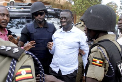 Former presidential candidate Kizza Besigye being dragged to a police van after he was blocked from leaving his home in Kasangati, Wakiso District, last Saturday. He was later detained at Naggalama Police Station.