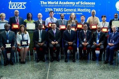 President Kagame (c) Prof. Bai Chunli, president of the World Academy of Sciences (TWAS-to his right), and Education minister Papias Musafiri (third from left) pose in a group picture with members of the TWAS Executive Council and award recipients.