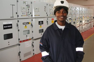 Likonge Makai Mulenga in front a substation she worked on.