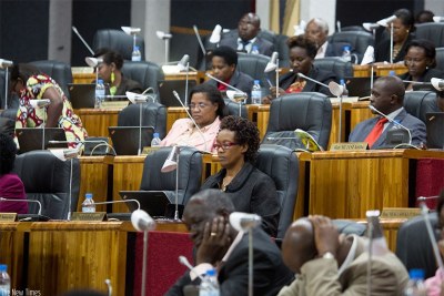 Lawmakers follow proceedings in Parliament during the debate.