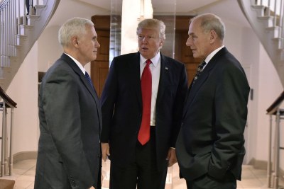 U.S. President Trump speaking with Vice President Mike Pence and Secretary of Homeland Security John F. Kelly.