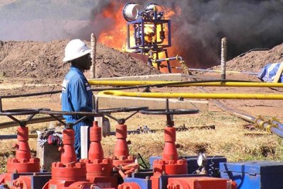 An expert watches a flaring experiment at one of the wells in the Albertine Graben (file photo).