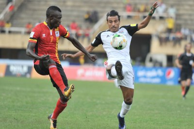 Emmanuel Okwi of Uganda battles against Abouzeid Mohamed of Egypt during the World Cup Qualifiers at Mandela Stadium, Namboole.