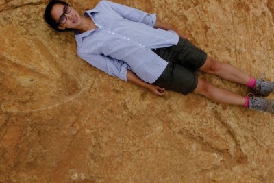 A 1.6m tall student, Miengah Abrahams, illustrates how large the tracks of the dinosaur are.