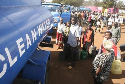 City residents queue to get water from water tankers.
