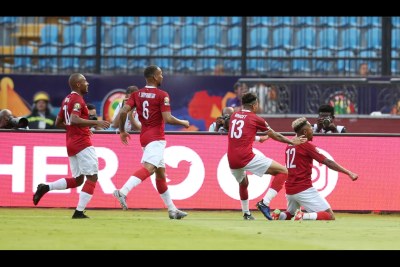 Madagascar players celebrate after scoring a goal against Nigeria.