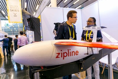 Participants at the Africa Drone Forum inspect one of the drones by Zipline at the exhibition.