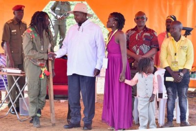 President Yoweri Museveni greets Mark Bugembe, alias Buchaman (left), Bobi Wine’s former vice president in the music recording outfit, Fire Base Crew (file photo).