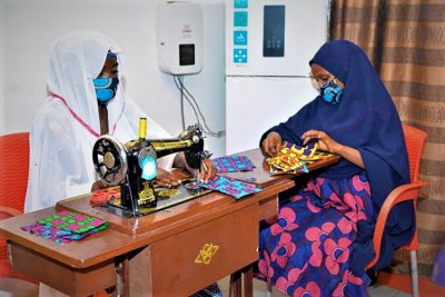 Women - most widowed or otherwise made vulnerable by the Boko Haram insurgency - are producing facemasks using the traditional Ankara fabric, to protect the population from the COVID-19 pandemic in Nigeria’s conflict-affected Northeast. Initial training for the women by professional tailors in Maiduguri, was supported by the U.S. Agency for International Development.